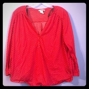 H&M red v-neck blouse with white designs.